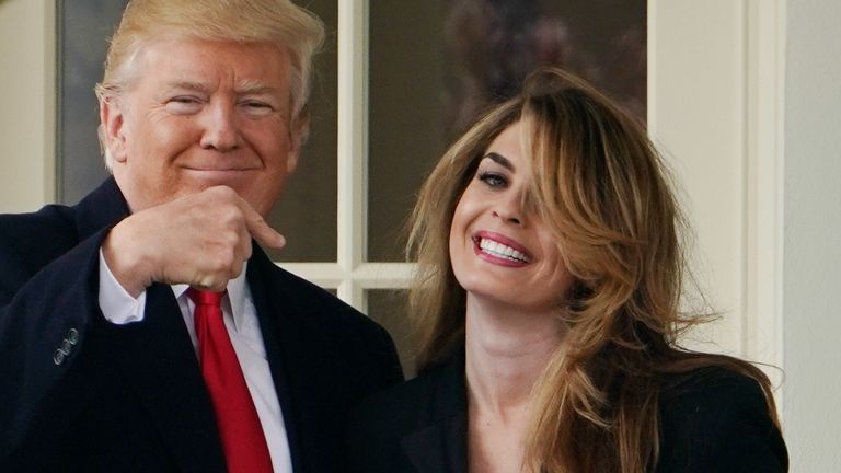 US President Donald Trump points to former communications director Hope Hicks shortly before making his way to board Marine One on the South Lawn and departing from the White House on March 29, 2018