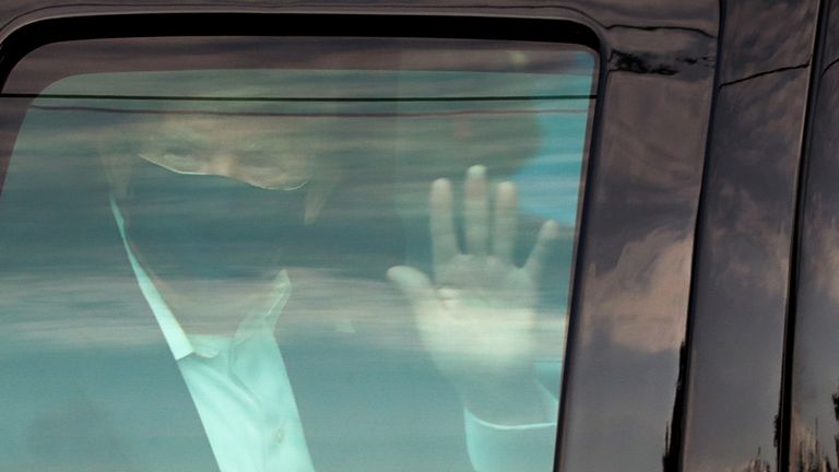Donald Trump waves to supporters as he rides by in the presidential motorcade in front of Walter Reed National Military Medical Center