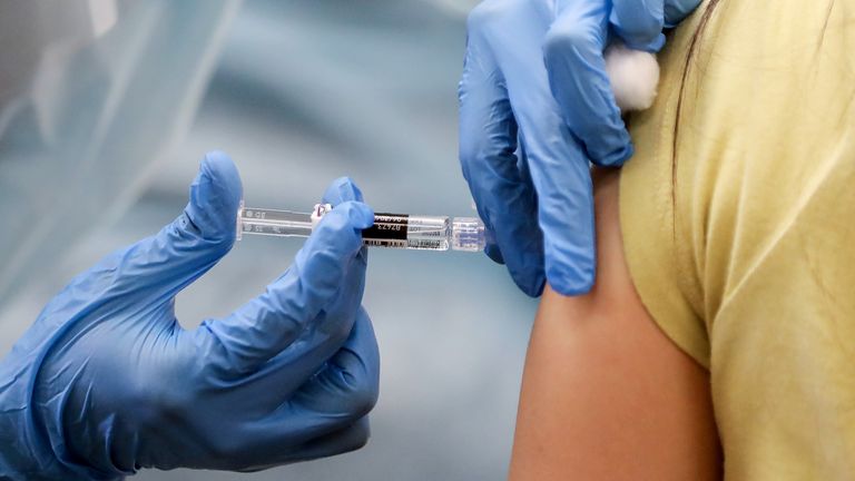 A woman in California is given a flu shot
