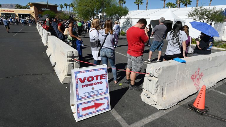 People line up to vote at a shopping center on the first day of in-person early voting  in Las Vegas, Nevada.