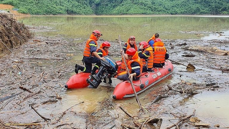 Vietnamese search and rescue personnel attempt a rescue at the Huong Dien hydroelectric project after landslides