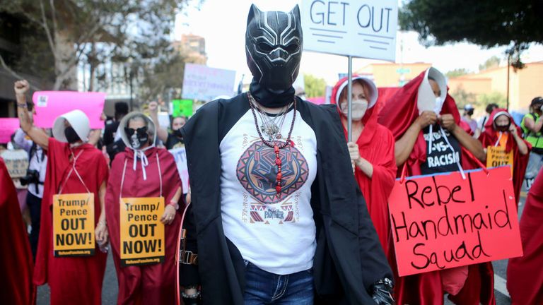 Protesters march during a Women’s March advocating for women&#39;s rights on October 17, 2020 in Los Angeles, California