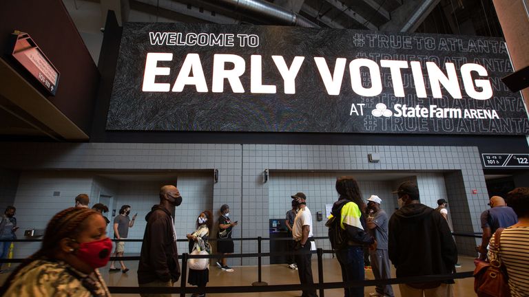 ATLANTA, GA - OCTOBER 12: Voters line up inside of State Farm Arena, Georgia's largest early voting location, for the first day of early voting in the General Election on October 12, 2020 in Atlanta, Georgia. Early voting in Georgia runs October 12-30. (Photo by Jessica McGowan/Getty Images)
