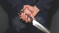 PICTURE POSED BY MODEL. Undated file photo of a man holding a knife. The number of knife crimes in England and Wales has risen 6% to a new record high, official figures show.