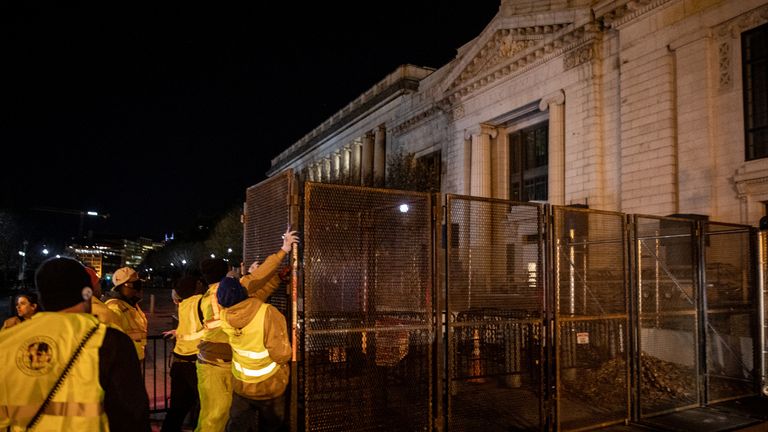 WASHINGTON, DC - NOVEMBER 2: Workers install a metal fence at an entrance to the White House in anticipation of riots related to the November 2, 2020 presidential election in Washington DC.  Preparations continue across Washington DC ahead of the November 3 US presidential election, with many business owners embarking and securing their stores in anticipation of protests and riots.  (Photo by Chris McGrath / Getty Images)