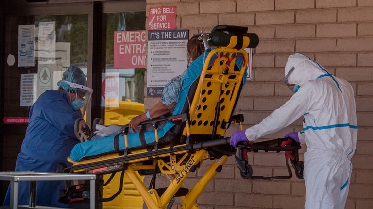 A patient is taken from an ambulance to the emergency room of a hospital in the Navajo Nation town of Tuba City during the 57 hour curfew, imposed to try to stop the spread of the Covid-19 virus through the Navajo Nation, in Arizona on May 24, 2020 - Weeks of delays in delivering vital coronavirus aid to Native American tribes exacerbated the outbreak, the president of the hard-hit Navajo Nation said, lashing the administration of President Donald Trump for botching its response. Jonathan Nez told AFP in an interview that of the $8 billion promised to US tribes in a $2.2 trillion stimulus package passed in late March, the first tranche was released just over a week ago. (Photo by Mark RALSTON / AFP) (Photo by MARK RALSTON/AFP via Getty Images)