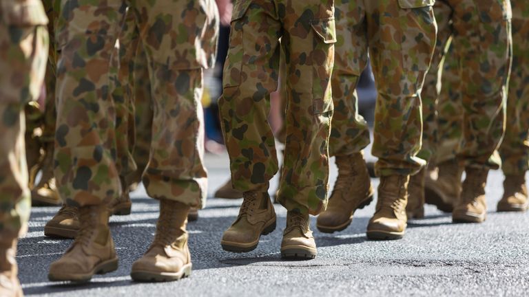 Feet of soldiers marching at an ANZAC Day parade on the streets of a regional country town