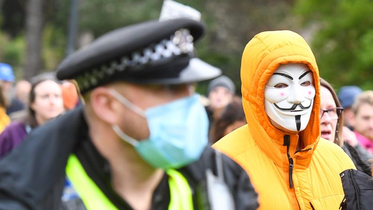 BOURNEMOUTH, ENGLAND - NOVEMBER 21: An anti-lockdown protester is seen in a Guy Fawkes mask as the march heads through the town centre on November 21, 2020 in Bournemouth, England. (Photo by Finnbarr Webster/Getty Images)