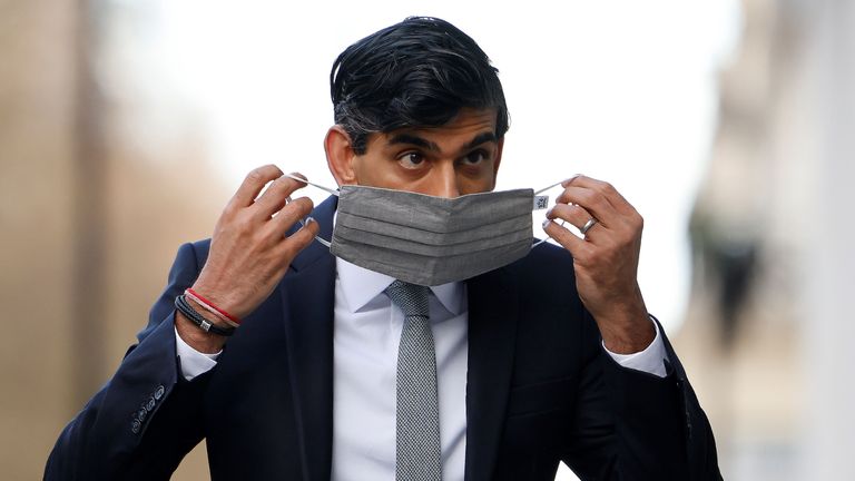 Britain's Chancellor of the Exchequer Rishi Sunak puts on a face covering due to the COVID-19 pandemic, as enters the BBC in central London on November 22, 2020, to take appear on the BBC political programme The Andrew Marr Show. - Britain's debt is now at its highest level since 1961 as a share of GDP, after the government embarked on a massive spending spree to mitigate the economic effects of the COVID-19 coronavirus pandemic and resulting lockdowns. (Photo by Tolga Akmen / AFP) (Photo by TOLGA AKMEN/AFP via Getty Images)