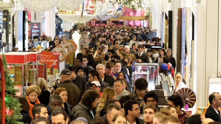 Shoppers crowd the aisles in Macys department store in Herald Square, New York, on November 26, 2015. Many retail outlets opened their doors to bargain hunters looking for Black Friday deals on Thanksgiving day, a day earlier than the traditional start to the sales season.  AFP PHOTO/TREVOR COLLENS / AFP / TREVOR COLLENS        (Photo credit should read TREVOR COLLENS/AFP via Getty Images)