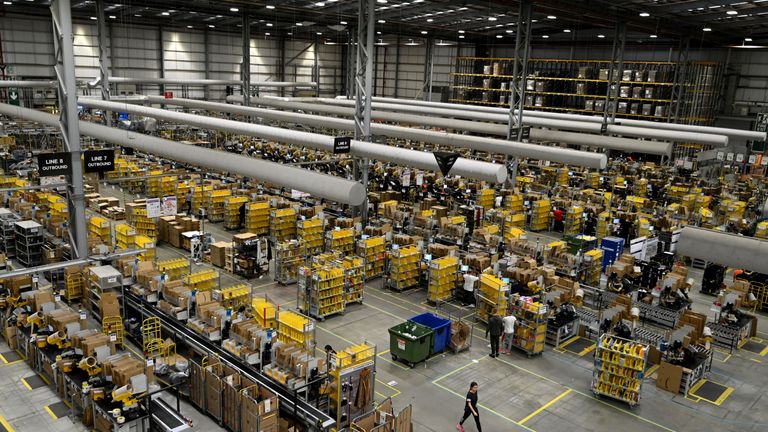 Amazon workers sort and pack items at the Amazon Fulfilment Centre in Peterborough, east England on November 27, 2019, as preparations are underway for the annual Black Friday Sale. (Photo by DANIEL LEAL-OLIVAS / AFP) (Photo by DANIEL LEAL-OLIVAS/AFP via Getty Images)