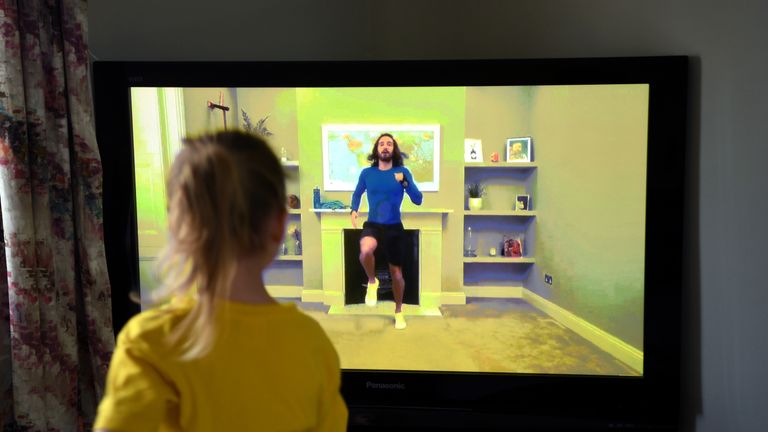 NEWCASTLE UNDER LYME, UNITED KINGDOM - MARCH 23: Four-year-old Lois Copley-Jones, who is the photographer's daughter, takes part in a live streamed broadcast of PE with fitness trainer Joe Wicks on the first day of the nationwide school closures on March 23, 2020 in Newcastle Under Lyme, United Kingdom. Coronavirus (COVID-19) pandemic has spread to at least 182 countries, claiming over 10,000 lives and infecting hundreds of thousands more. (Photo by Gareth Copley/Gareth Copley)