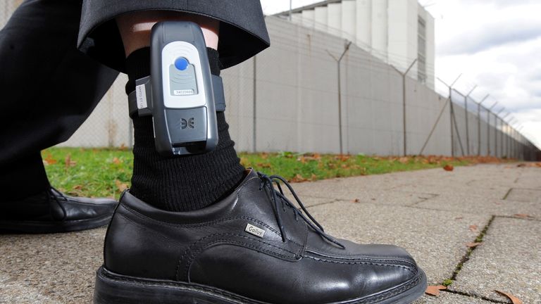 A man has an electronic tag attached to his ankle during a presentation of the device at a press conference in Stuttgart-Stammheim, Germany, 10 November 2010. After positive experience during test runs, more prisoners in the Baden-Wuerttemberg |