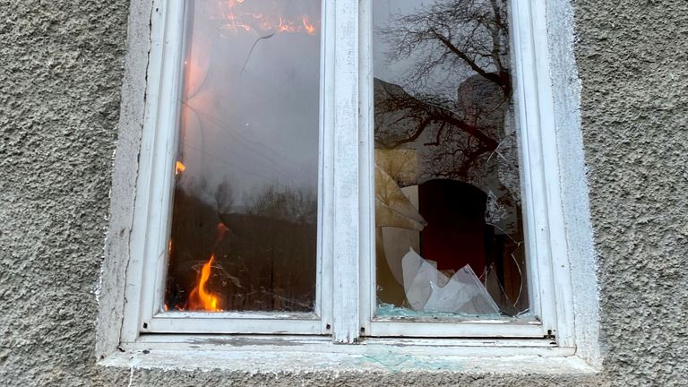 Flames burn through a window