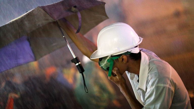 A demonstrator holds an umbrella as he protects himself from water cannons during an anti-government protest as lawmakers debate on constitution change, outside of the parliament in Bangkok, Thailand, November 17, 2020. REUTERS/Jorge Silva