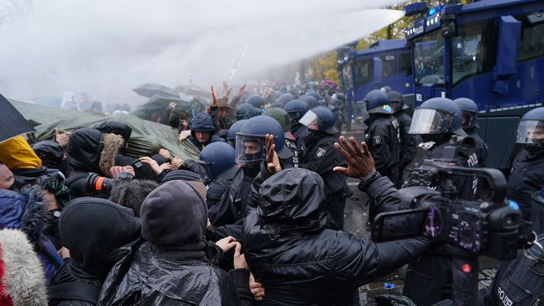 Water cannons were fired as riot police pushed back protesters