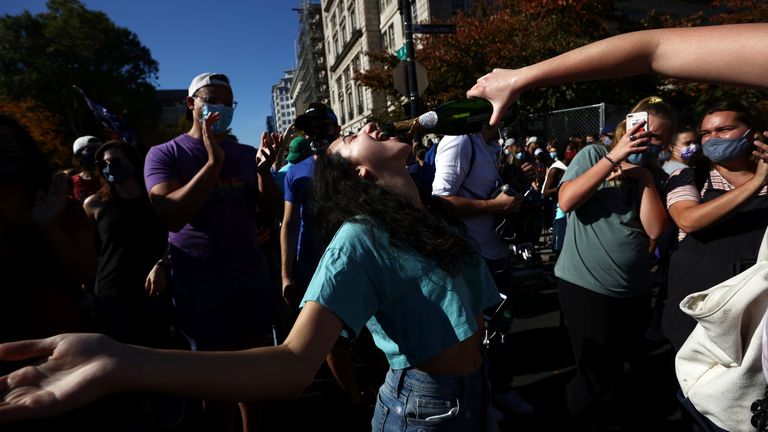 People react as media announce that Democratic U.S. presidential nominee Joe Biden has won the 2020 U.S. presidential election, on Black Lives Matter Plaza in Washington, U.S., November 7, 2020. REUTERS/Hannah McKay
