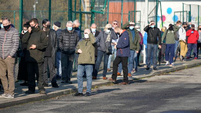 Members of the public queue at a mass Covid-19 testing site in the Liverpool 