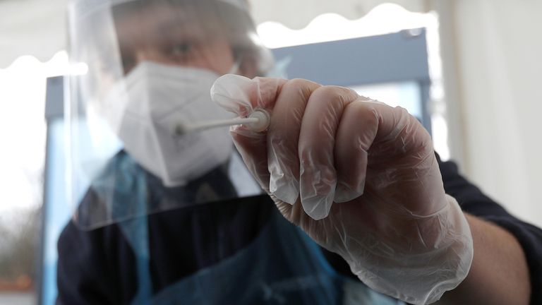 A swab is taken at a testing facility at Gatwick