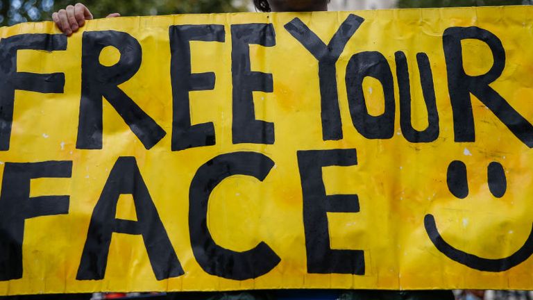 LONDON, ENGLAND - OCTOBER 10: An anti-mask protestor holds a sign during a rally outside Downing Street on October 10, 2020 in London, England. Demonstrators rallied against the COVID-19 measures a day after London&#39;s Mayor Sadiq Khan announced new restrictions &#39;inevitable&#39;. The World Health Organization (WHO) health agency announced "no new answers" to the coronavirus pandemic and reporting a worldwide record of 350,000 new daily cases. (Photo by Hollie Adams/Getty Images)