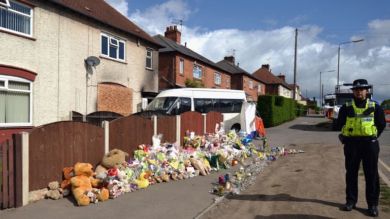 Floral tributes adorn the pavement outside a house in Allerton after a fire claimed the lives of six children on May 14, 2012 in Derby, England. Duwayne Philpott, aged 13 his sister Jade, 10, and  brothers John, nine, Jack, seven, Jessie, six, and Jayden, five died in the fire which started in the early hours of last Friday. The children&#39;s father Mick Philpott, who is believed to have 17 children has been praised for his "valiant attempts" to save them...