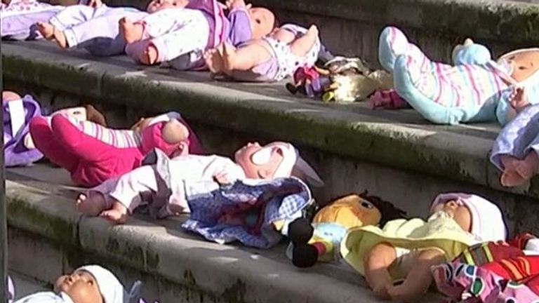 Dolls are laid on the steps of the Treasury