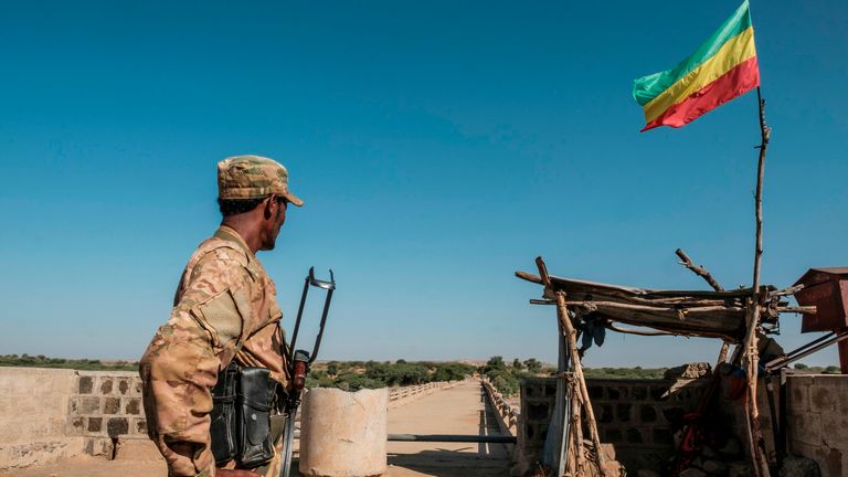 A member of the Amhara Special Forces watches on at the border crossing with Eritrea while where an Imperial Ethiopian flag waves, in Humera, Ethiopia, on November 22, 2020. - Prime Minister Abiy Ahmed, last year&#39;s Nobel Peace Prize winner, announced military operations in Tigray on November 4, 2020, saying they came in response to attacks on federal army camps by the party, the Tigray People&#39;s Liberation Front (TPLF). Hundreds have died in nearly three weeks of hostilities that analysts worry c