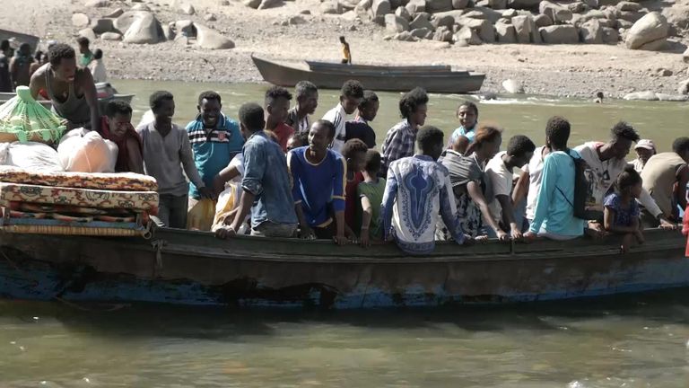 Refugees climbed into unstable metal boats to flee the fighting in Tigray