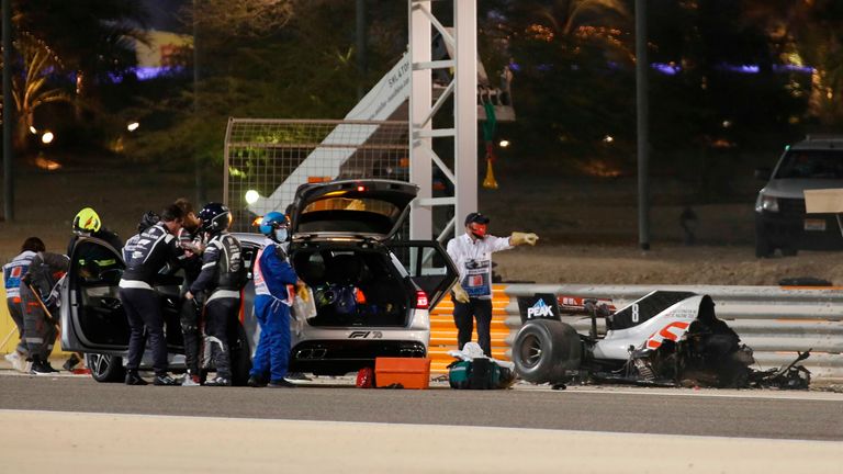 TOPSHOT - Haas F1&#39;s French driver Romain Grosjean&#39;s car burns after crashing during the Bahrain Formula One Grand Prix at the Bahrain International Circuit in the city of Sakhir on November 29, 2020. (Photo by KAMRAN JEBREILI / POOL / AFP) (Photo by KAMRAN JEBREILI/POOL/AFP via Getty Images)
