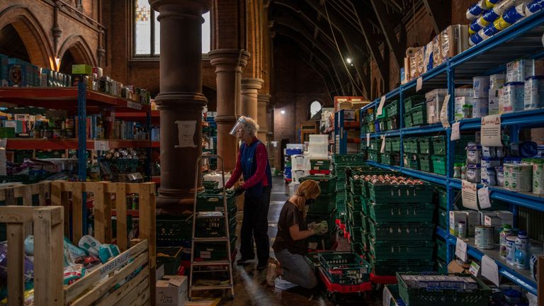 LONDON, ENGLAND - OCTOBER 27: Staff and volunteers pack and prepare food parcels at the South London warehouse and distribution centre at St Margaret&#39;s Church on October 27, 2020 in London, England. 