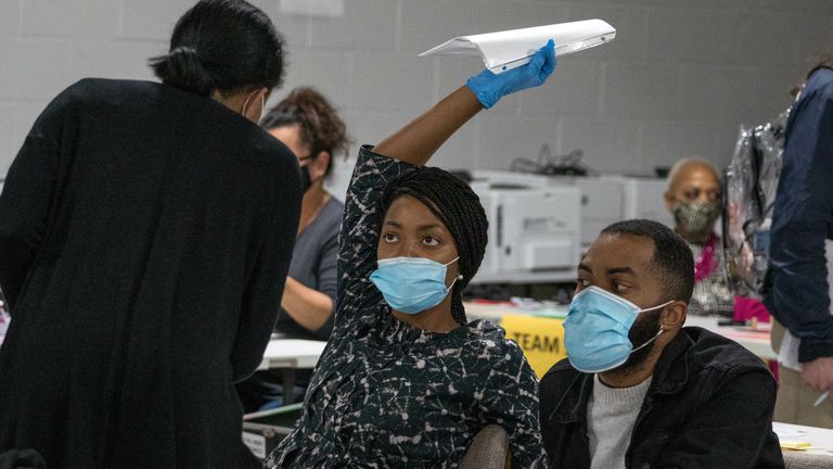 Gwinnett County election workers handle ballots as part of the recount for the 2020 presidential election at the Beauty P. Baldwin Voter Registrations and Elections Building on November 16, 2020 in Lawrenceville, Georgia. 