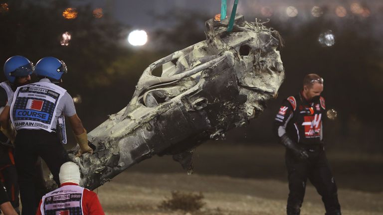 Wreckage of Haas F1&#39;s French driver Romain Grosjean&#39;s car is removed during the Bahrain Formula One Grand Prix at the Bahrain International Circuit in the city of Sakhir on November 29, 2020. (Photo by HAMAD I MOHAMMED / POOL / AFP) (Photo by HAMAD I MOHAMMED/POOL/AFP via Getty Images)
