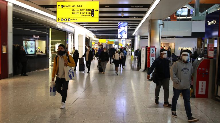 LONDON, ENGLAND - OCTOBER 20: Passengers are pictured preparing to travel by air wearing protective masks on October 20, 2020 at Heathrow Terminal 5 Airport in London, United Kingdom. The British government is being pressed to create a covid-19 testing system to ease restrictions on inbound and outbound travelers. (Photo by Warren Little/Getty Images)