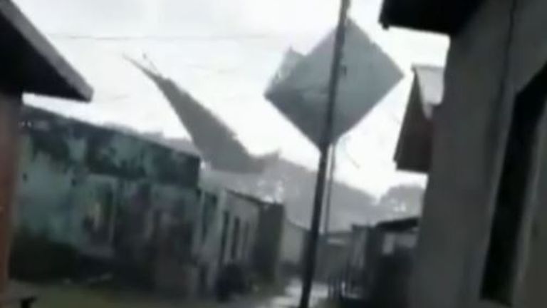 Section of a building flies through air during storm in Honduras