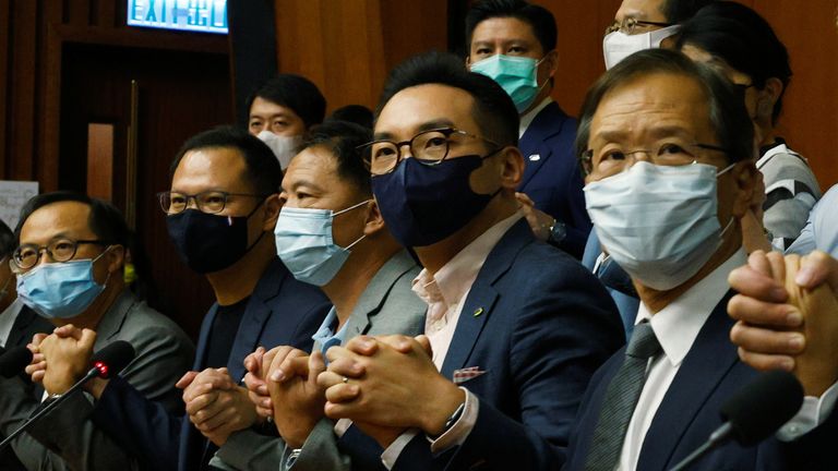 Kenneth Leung, Dennis Kwok, Wu Chi-wai, Alvin Yeung and Kwok Ka-ki join their hands together during a news conference