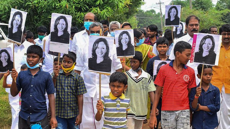 Residents hold placards with the portrait of US Democratic Vice President-Elect Kamala Harris, as they celebrate her victory in the US election, at her ancestral village of Thulasendrapuram in the southern Indian state of Tamil Nadu on November 8, 2020. - Residents set off firecrackers in the ancestral home of Kamala Harris on November 8 as India celebrated the vice president-elect&#39;s victory in the US election, as others hailed her achievement as historic and a "proud moment" for the country. (P