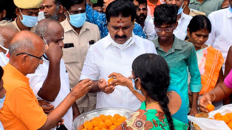 Residents distributes sweets as they celebrate the victory of US Democratic Vice President-Elect Kamala Harris, at her ancestral village of Thulasendrapuram in the southern Indian state of Tamil Nadu on November 8, 2020. - Residents set off firecrackers in the ancestral home of Kamala Harris on November 8 as India celebrated the vice president-elect&#39;s victory in the US election, as others hailed her achievement as historic and a "proud moment" for the country. (Photo by STR / AFP) (Photo by STR/