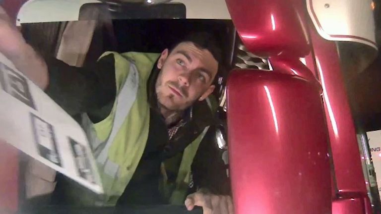 Lorry driver Maurice Robinson is seen leaving Purfleet port in Essex after collecting the trailer containing the migrants