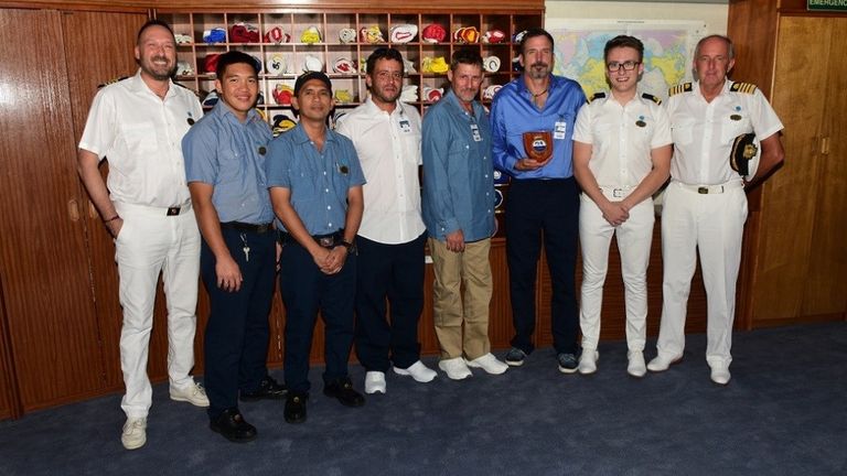 Max Bingle (2R) and crew with the rescued sea-farers. Pic: Princess Cruises
