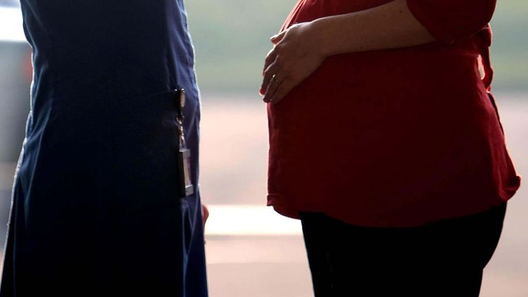 File photo dated 19/2/2008 of a midwife talking to a pregnant woman. Midwives are delaying going to the toilet and skipping meals because they lack time to take breaks, a survey has suggested.