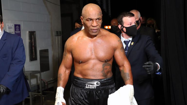 Nov 28, 2020; Los Angeles, CA, USA; Mike Tyson (black trunks) exits the ring after his split draw against Roy Jones, Jr. (white trunks) during a heavyweight exhibition boxing bout for the WBC Frontline Belt at the Staples Center. Mandatory Credit: Joe Scarnici/Handout Photo via USA TODAY Sports