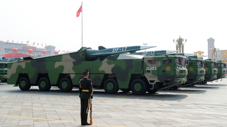 Military vehicles carrying hypersonic missiles DF-17 drive past Tiananmen Square