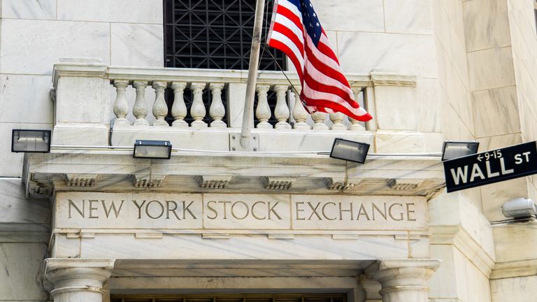 New York City, USA- June 08, 2015 - The New York Stock Exchange building on Wall Street, with a US flag flying on a flag pole