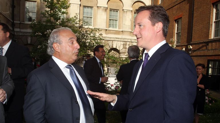 Prime Minister David Cameron talks to Sir Philip Green