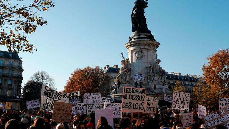 Demonstrators hold signs reading &#39;Ministry of shame&#39; and &#39;Powerful people above the laws&#39; on the Place de la Republique 