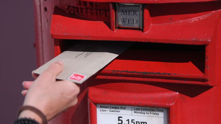 PENARTH, WALES - APRIL 15: A letter is posted into a red postbox on April 15, 2020 in Penarth, Wales. The Coronavirus (COVID-19) pandemic has spread to many countries across the world, claiming over 120,000 lives and infecting over 2 million people. (Photo by Stu Forster/Getty Images)