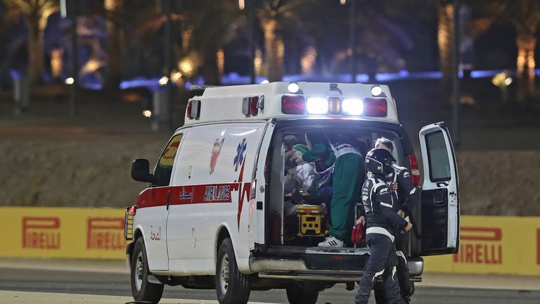 Medics attend to Haas F1&#39;s French driver Romain Grosjean after the crash