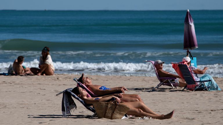People sunbathe near Valencia in Spain