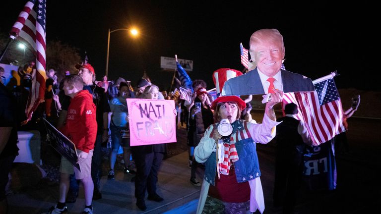 Esperanza Igarashi, a supporter of President Donald Turmp, holds a cardboard cutout of Trump during a "Stop the Steal" protest at Clark County Election Center in North Las Vegas, Nevada, U.S. November 5, 2020. REUTERS/Steve Marcus