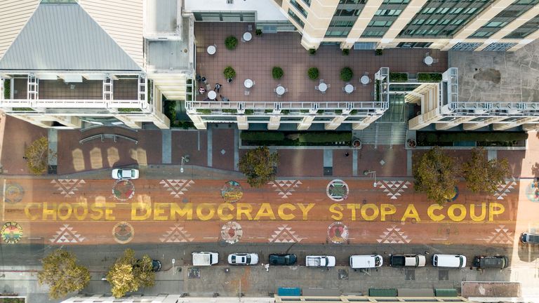 In an aerial view from a drone, a mural that reads "Choose Democracy Stop a Coup" is seen painted on 14th Street on November 10, 2020 in downtown Oakland, California